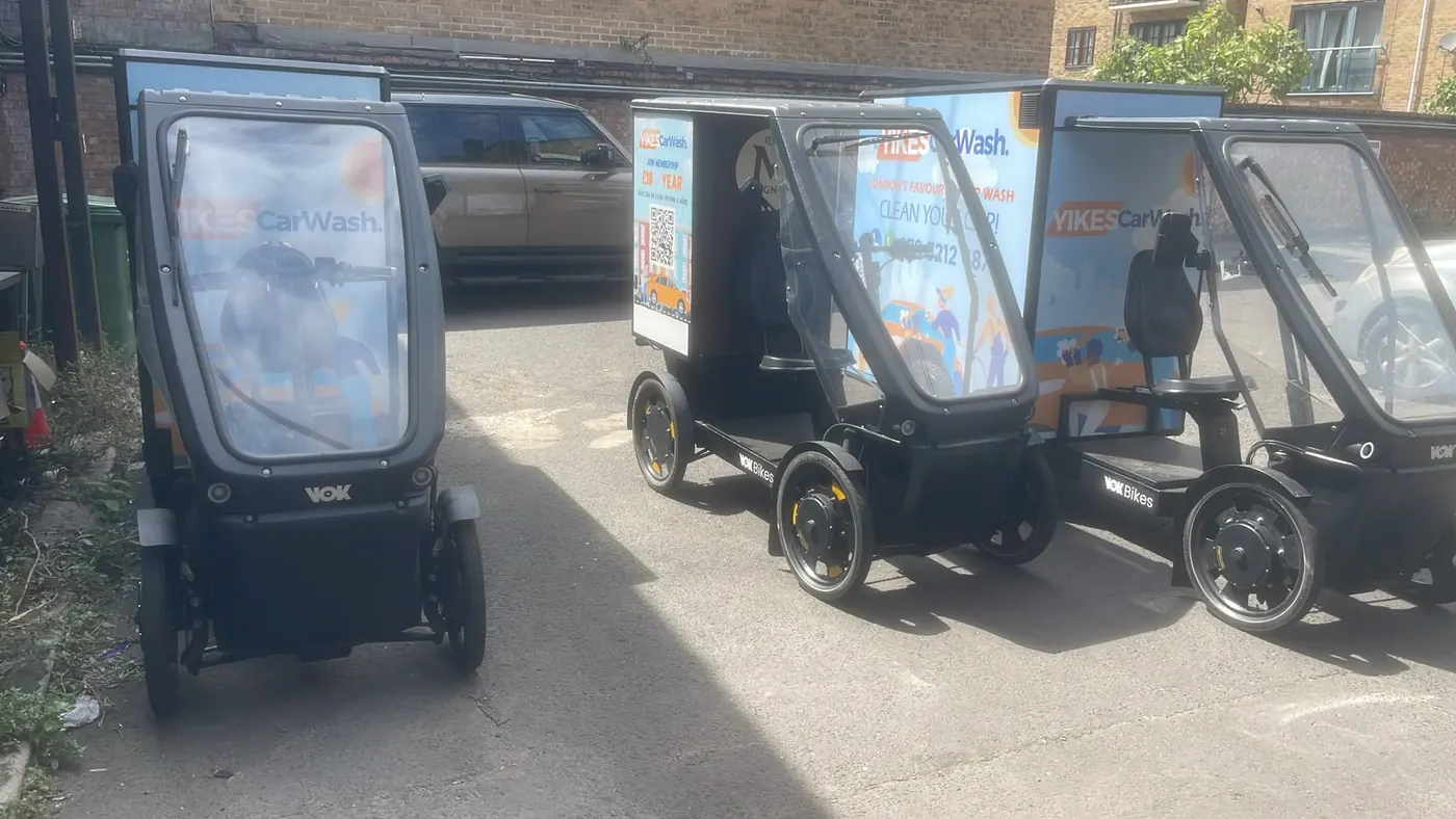Three Yikes cargo e-bike wash units lined up in the yard before the day's rounds