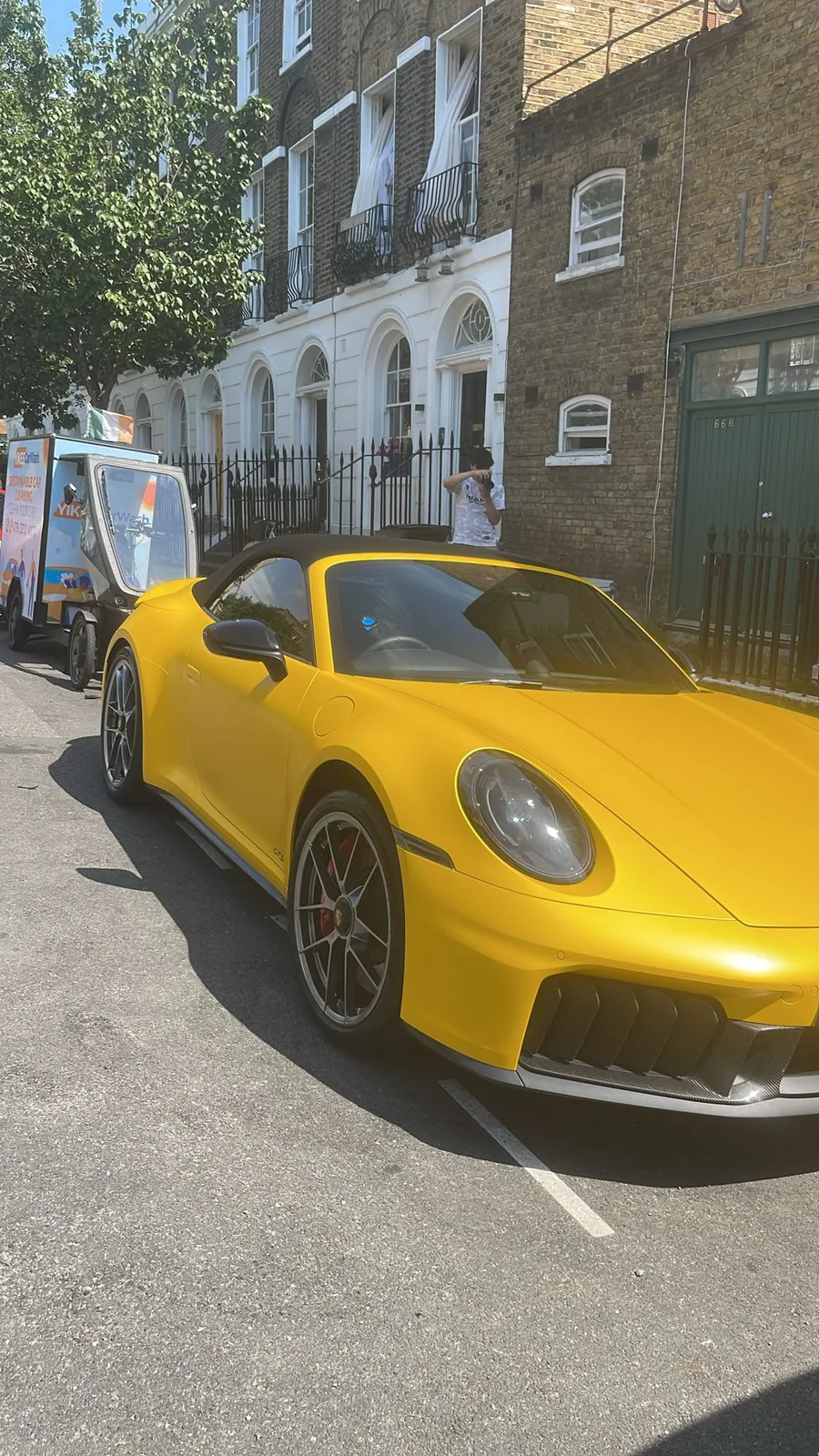 Matte yellow Porsche 911 GTS hand washed by Yikes on its own street