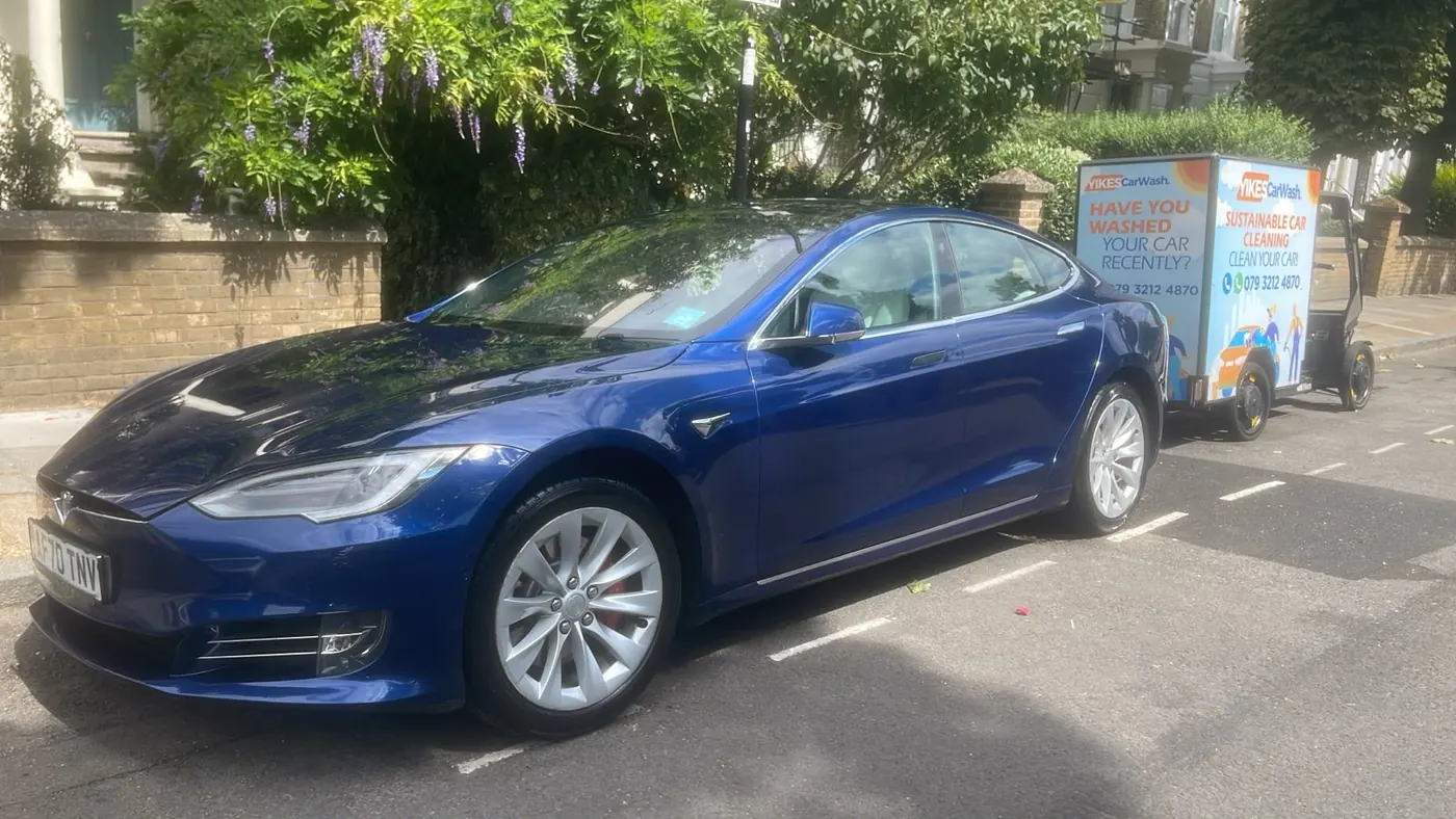 Blue Tesla Model S with deep reflective gloss parked kerbside before a Yikes mobile ceramic coating visit